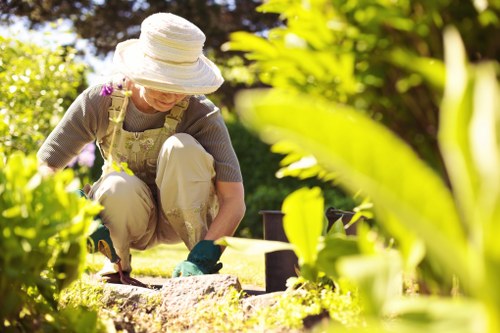 Worker using protective equipment during garden maintenance tasks